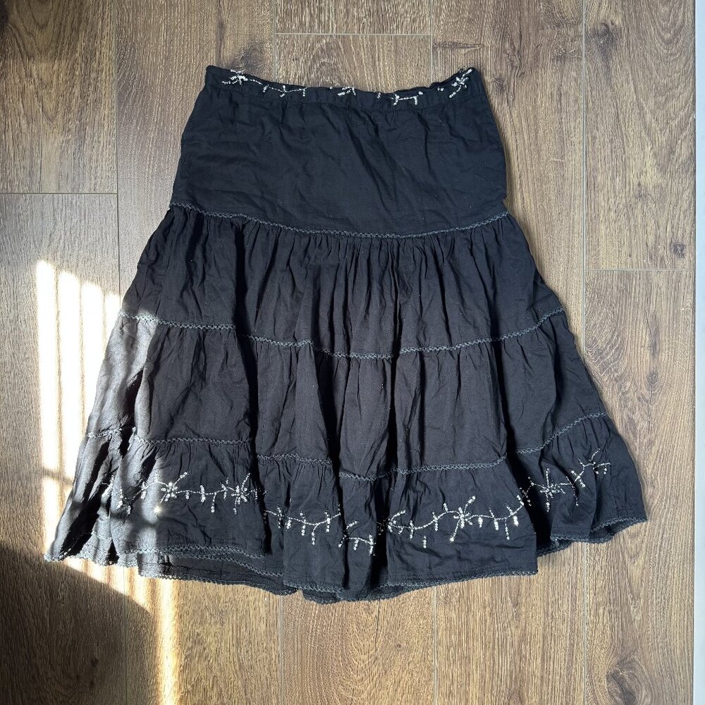 black midi length tiered skirt with grey trim and silver sequin details